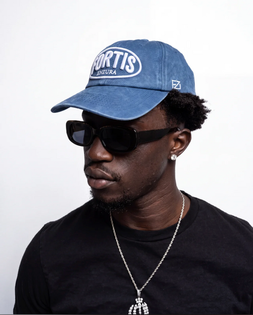 Washed navy ENZURA cap, angled view showing the six-panel crown and curved brim