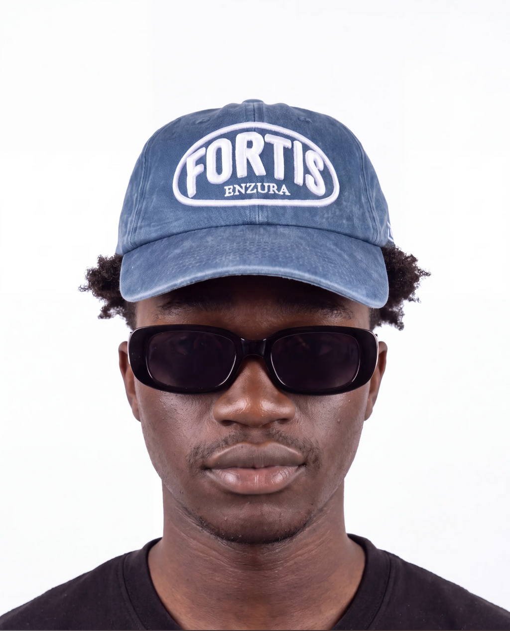 Washed navy ENZURA cap, front view, showing the white FORTIS puff embroidery