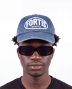 Washed navy ENZURA cap, front view, showing the white FORTIS puff embroidery